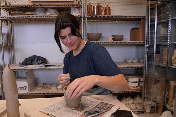 Art student in a ceramics studio working on her ceramics project